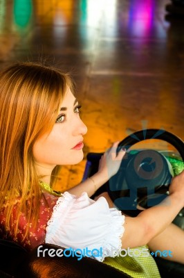 Beautiful Girl In An Electric Bumper Car At Amusement Park Stock Photo