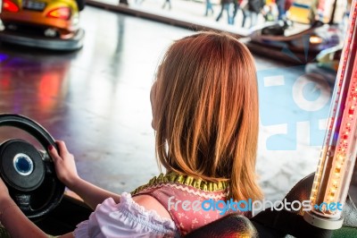 Beautiful Girl In An Electric Bumper Car In Amusement Park Stock Photo