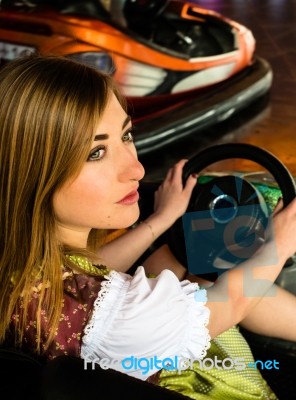 Beautiful Girl In An Electric Bumper Car In Amusement Park Stock Photo