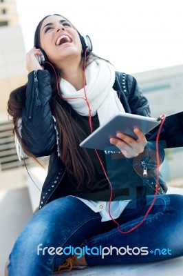 Beautiful Girl Listening To Music In City Stock Photo