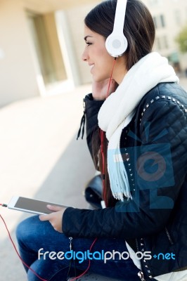 Beautiful Girl Listening To Music In City Stock Photo