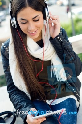 Beautiful Girl Listening To Music In City Stock Photo