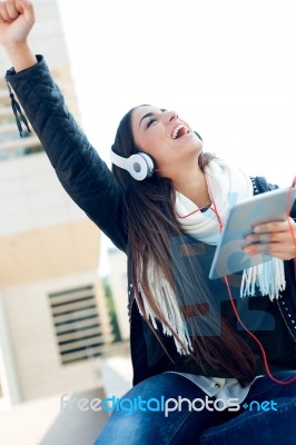 Beautiful Girl Listening To Music In City Stock Photo