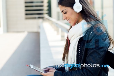 Beautiful Girl Listening To Music In City Stock Photo