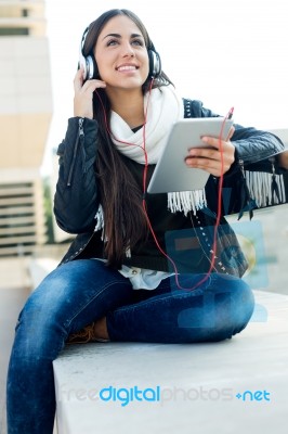 Beautiful Girl Listening To Music In City Stock Photo