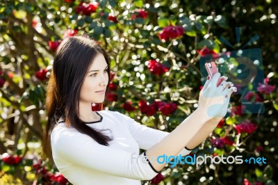 Beautiful Girl Posing For A Selfie With Her Smart Phone Stock Photo