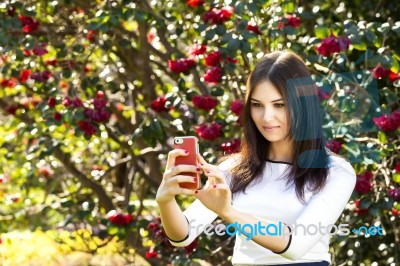 Beautiful Girl Posing For A Selfie With Her Smart Phone Stock Photo