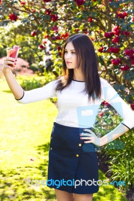 Beautiful Girl Posing For A Selfie With Her Smart Phone Stock Photo