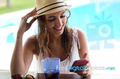 Beautiful Girl Taking A Mobile Phone At The Swimming Pool Stock Photo