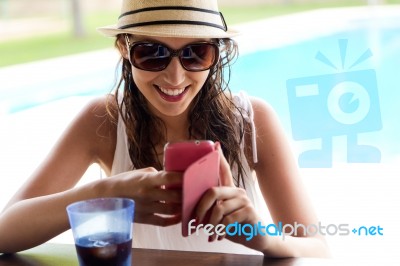 Beautiful Girl Taking A Mobile Phone At The Swimming Pool Stock Photo