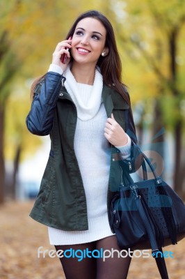 Beautiful Girl Talking On Phone In Autumn Stock Photo