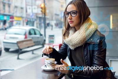 Beautiful Girl Using Her Mobile Phone In Cafe Stock Photo