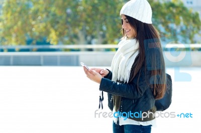 Beautiful Girl Using Her Mobile Phone In City Stock Photo