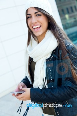 Beautiful Girl Using Her Mobile Phone In City Stock Photo