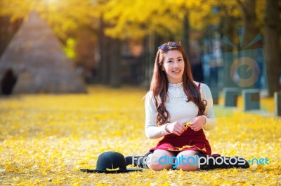 Beautiful Girl With Yellow Leaves In Nami Island, Korea. Nami Island In Autumn Stock Photo