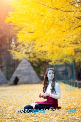 Beautiful Girl With Yellow Leaves In Nami Island, Korea. Nami Island In Autumn Stock Photo