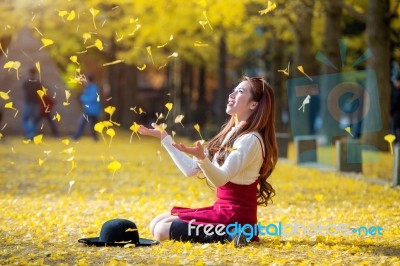 Beautiful Girl With Yellow Leaves In Nami Island, Korea. Nami Island In Autumn Stock Photo