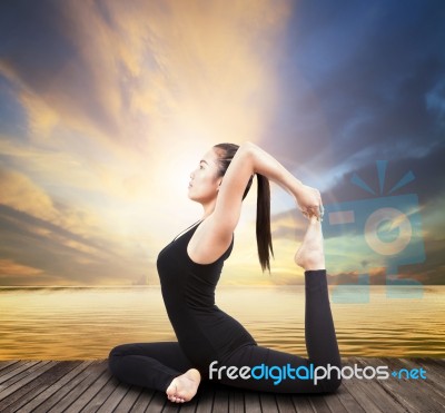 Beautiful Health Care Asian Woman Posting Yoga At Wood Terrace Sea Side Stock Photo