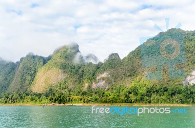 Beautiful High Mountains And Green Lake Stock Photo