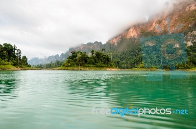 Beautiful High Mountains And Green Lake Stock Photo