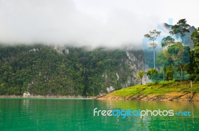 Beautiful High Mountains And Green Lake Stock Photo