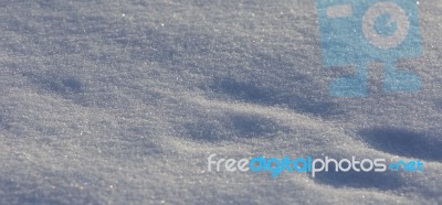 Beautiful Isoalted Picture Of A Sunny White Snow With The Footprints Stock Photo