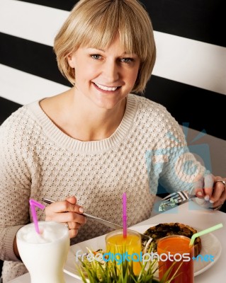 Beautiful Middle Aged Lady Enjoying Her Meal Stock Photo