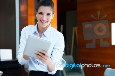 Beautiful Modern Businesswoman Holding Tablet Computer Stock Photo