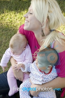 Beautiful Mother Posing With Her Two Kids Stock Photo