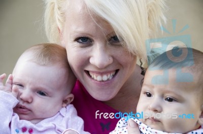 Beautiful Mother Posing With Her Two Kids Stock Photo