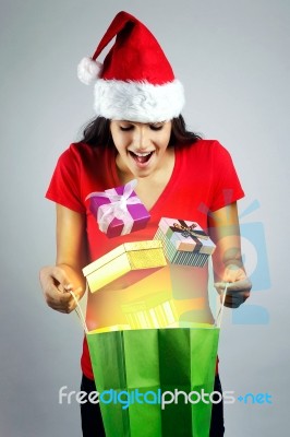 Beautiful Santa Girl Watching Out Gifts From A Magic Shopping Ba… Stock Photo