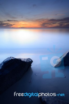 Beautiful Seascape Of Wave And Rock At The Sunrise Stock Photo