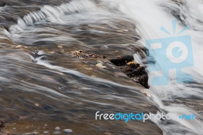 Beautiful Small Waterfalls Of A Fast Creek In Fall Stock Photo