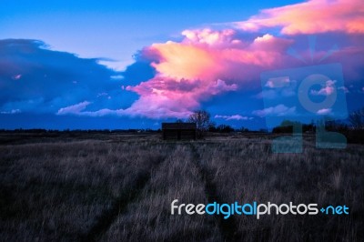 Beautiful Sunset Over Old Log Cabin Stock Photo