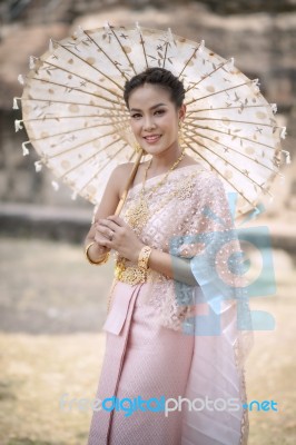 Beautiful Thai Woman Wearing Old Thai Tradition Clothes Style Holding Bamboo Wood Umbrella With Toothy Smiling Face Stock Photo