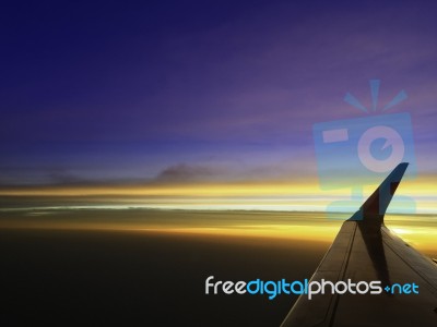 Beautiful Twilight Cloud Sky Through Airplane Wing Stock Photo