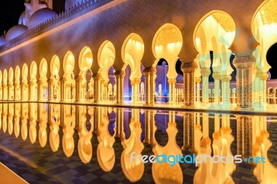 Beautiful Walkway Illuminated At Night In Abu Dhabi Sheikh Zayed Grand Mosque, Uae Stock Photo