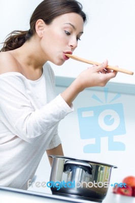 Beautiful Woman Cooking At The Kitchen Stock Photo