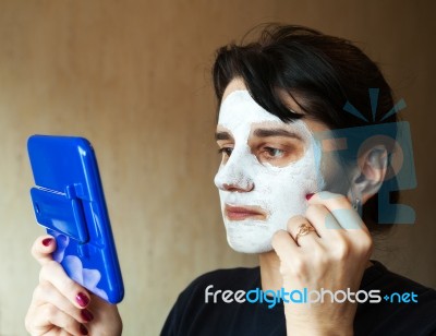 Beautiful Woman Gets Cosmetic Mask In The Mirror Stock Photo