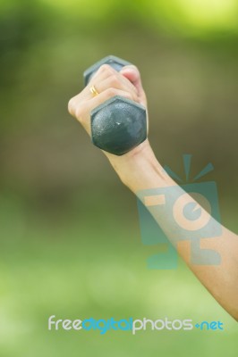 Beautiful Woman Holding Weights Stock Photo