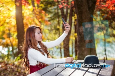 Beautiful Woman In Fall Forest Park Taking Selfie Self Photo With Smartphone Stock Photo