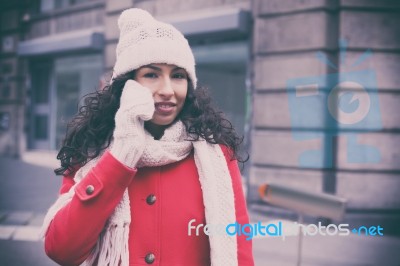 Beautiful Woman In Red Coat And Wool Cap And Gloves With Smartph… Stock Photo