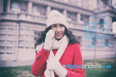 Beautiful Woman In Red Coat And Wool Cap And Gloves With Smartph… Stock Photo