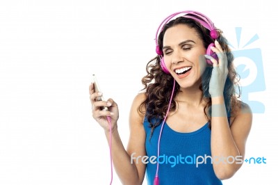 Beautiful Woman Listening Music On Her Cell Phone Stock Photo