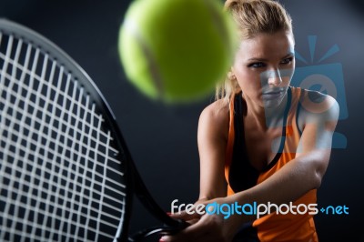 Beautiful Woman Playing Tennis Indoor. Isolated On Black Stock Photo