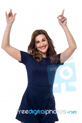 Beautiful Woman Pointing Up Stock Photo