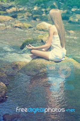 Beautiful Woman Practive Yoga On River In Nature Stock Photo