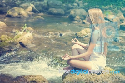 Beautiful Woman Practive Yoga On River In Nature Stock Photo