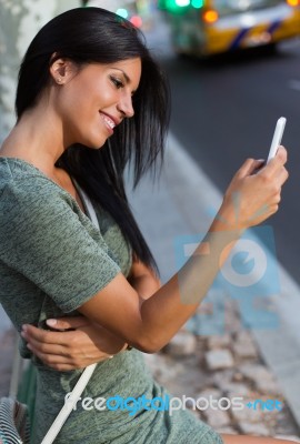 Beautiful Woman Use Her Phone In The City At Night Stock Photo