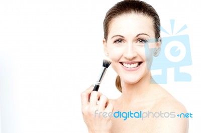 Beautiful Woman Using Make Up Brush Stock Photo